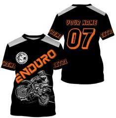 a black shirt with an orange and white design on the front, featuring a motorcycle rider