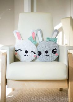 two crocheted stuffed animals sitting on top of a white chair