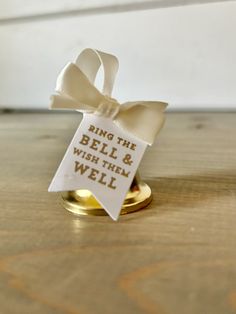 a ring with a sign that says ring the bell and wish them well on it