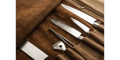 three different types of knives in a leather case