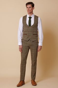 Channel traditional English gent vibes with the Ted suit. Crafted with heritage inspired wool-mix cloth, this suit adopts a herringbone weave in earthy tones and works beautifully for a country barn wedding look. The multi-tonal check is synonymous with 19th century tweeds yet the colour pop accents give it that modern edge to easily fit into your 21st century wardrobe. Also available in a matching child's size. Model wears size 40R blazer, 40R waistcoat & 34R trousers. Features Herringbone Slim Brown Tweed Suit With Herringbone Pattern, Tweed Three-piece Business Suit For Fall, Business Tweed Three-piece Suit For Fall, Brown Fitted Tweed Suits, Fitted Brown Tweed Suits, Fall Business Tweed Three-piece Suit, Tailored Brown Tweed Suits, Fitted Brown Suits With Herringbone Pattern, Brown Fitted Herringbone Suit