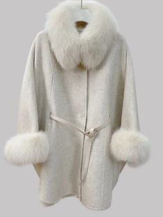 MODA  FURS  FABULOUS FUR FASHIONS AT UNBEATABLE PRICES   This elegant ladies' garment is made of wool / cashmere and is brand new. It features a stunning fox fur collar and cuffs, adding a touch of luxury and comfort. The stylish belt adds the perfect finishing touch to this beautiful wrap/cloak/coat/jacket. Additionally, this garment is extremely lightweight yet warm and can fit many sizes. One Size  Length: 32"      condition chart: FUR RESTYLING SERVICES:       SERVICES: Brand New    Never us Luxury Outerwear With Stand Collar, Beige Wool Shawl Collar Outerwear, Elegant Fur Cape Coat For Fall, Luxury Hooded Outerwear For Spring, Classic Outerwear With Faux Fur Trim For Winter, Classic Winter Outerwear With Faux Fur Trim, Classic Winter White Outerwear, Fitted Long Sleeve Winter Cape, Fitted Long Sleeve Cape For Winter