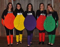 four women are dressed up in costumes made to look like the colors of the rainbow