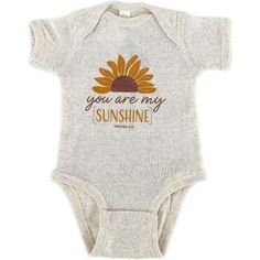 This short-sleeved onesie for babies is from our Mardel exclusive brand called New Ewe . This onesie is a heathered cream color with a depiction of a sunflower and that reads: you are my Sunshine Matthew 5:16 The material is 100% cotton and provides a relaxed and comfortable fit with a snap closure between the legs. Machine wash cold, use only non-chlorine bleach, and tumble dry low. Make sure not to iron the graphic. Dress your baby in clothing that shares your faith to others, and that allows Yellow Onesie For Spring, Casual Yellow Short Sleeve Onesie, Cream Short Sleeve Cotton Onesie, Yellow Short Sleeve Casual Onesie, You Are My Sunshine Onesie, Yellow Onesie For Summer Playtime, Cream Cotton Short Sleeve Onesie, Sunshine Onesie, Spring Yellow Short Sleeve Onesie