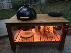 a bbq grill sitting on top of a wooden table