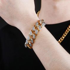 Extra bling for your wrist! The 18MM Cuban Link Bracelet is the perfect accessory to take your style up a notch. With its glittering cubic zirconia stones set in gold-plated metal, this bracelet adds a touch of luxury to any outfit. Whether you're dressing up for a special occasion or just looking to add a little sparkle to your everyday look, this bracelet is sure to turn heads. At an unbeatable price, there's no reason not to indulge in a little extra bling. So don't wait any longer, order you Gold Diamond Bracelet With Rhinestones For Gift, Gold Diamond Bracelet With Rhinestones As A Gift, Gold Diamond Chain Bracelet With Rhinestones, Gold Diamond Bracelet For A Gift, Cuban Link Bling Bracelets For Party, Adjustable Gold Bracelet With Rhinestones, Gold Bracelets With Rhinestones For Gifts, Gold Rhinestone Bracelets As Gift, Gold Rhinestone Bracelets For Gifts