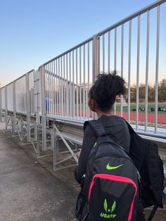 a person with a back pack walking up some stairs