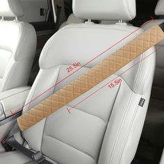 the interior of a car with an angled seat belt and beige stitching on it