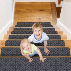 two young boys are sitting on the stairs