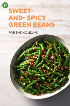 a bowl filled with green beans on top of a table