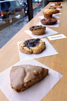 there are many different types of pastries on the table in front of each other