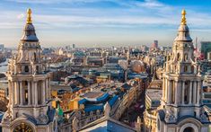 an aerial view of the city with tall buildings and spires in the foreground