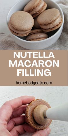 a person holding a cookie in front of a bowl with macaron filling on it