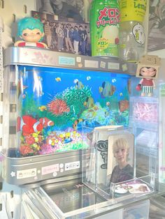 a boy looking at an aquarium in a store