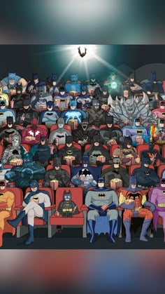 a group of people dressed up as batmans sitting in a movie theater with bats flying overhead