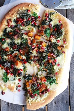 a pizza that is sitting on top of a cutting board with some toppings around it