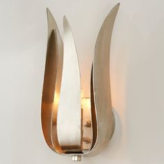 a wall light that is on the side of a wall with an unusual shaped design