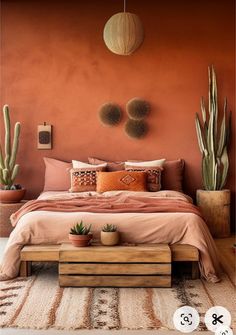 a bedroom with an orange wall and two cactus plants on the side of the bed