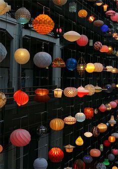 many different colored lanterns hanging from the ceiling