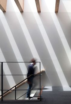 a man walking up the stairs in a building