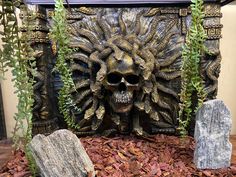 there is a fake skull in the middle of some plants