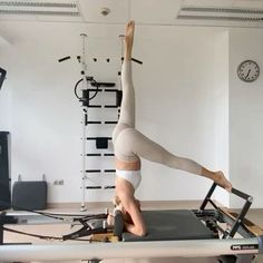 a woman is doing yoga on a machine