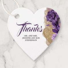 a white heart with purple flowers on it and the words thanks written in gold glitter