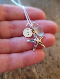 Personalized Sterling Starfish Beach lovers Necklace with Genuine Sea glass Sterling Silver Starfish Charm measures 3/4 inch Sterling Silver round 8mm initial charm can be stamped in lower case or upper case. Genuine Sea Glass measures 3/8 inch to 1/2 inch in size Shown in Sea foam- shades and shapes vary slightly (natural item) Sterling Silver Cable or Box chain: you choose style & length Comes beautifully packaged - ready to give as a gift or keep for yourself! In notes to seller please in Ocean-inspired Starfish Charm Necklace For Gift, Ocean-inspired Starfish Charm Necklace Gift, Starfish Charm Necklace Perfect For Gifts, Starfish Charm Necklace As Gift, Starfish Charm Necklaces For Gifts, Starfish Charm Necklaces As Gift, Moon Phases Necklace, Lovers Necklace, Starfish Necklace