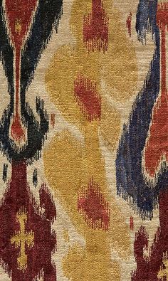 an area rug with various colors and designs on it, including red, yellow, blue, and black