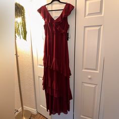 a red dress hanging on a white door