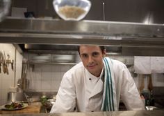 a man standing in a kitchen next to a counter