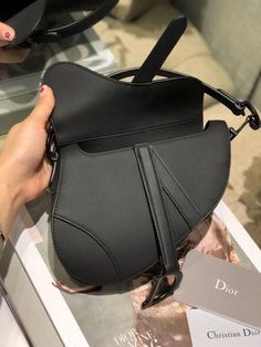 Description CHRSTN DR Mini Saddle Bag Black Ultramatte For Women 19.5cm/7.6in CD Rep 1:1 Measurements: 19.5 x 16 x 6.5 cm / 7.6 x 6.2 x 2.5 in The iconic Saddle bag, crafted in white , is reimagined by Maria Grazia Chiuri. The legendary design is embellished with a Oblique perforations motif and features a Saddle flap with a magnetic ‘D’ stirrup clasp and an antique finish metal ‘CD’ signature on either side of the strap. The bag has a wide embroidered strap, both adjustable and removable, and m Dior Mini Saddle Bag, Mini Saddle Bag, Dior Oblique, Book Tote Bag, Maria Grazia, Luxury Products, Evening Clutch Bag, Saddle Bag, Antique Finish