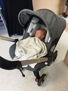 a baby is sleeping in a stroller