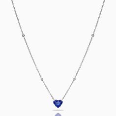 a blue heart shaped necklace with diamonds on it's sides and a white background