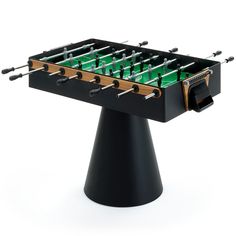 a table top foosball set up on a black stand