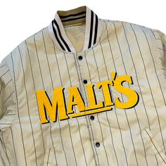 This limited edition vintage reversible Suntory Malts Baseball Team embroidered varsity jacket is rare! Only produced in limited runs, these promotional jackets are not available to the public and are specific to each promotion's era. Suntory is a Japanese multinational brewing and distilling group. Established in 1899, it is one of the oldest companies distributing alcoholic beverages in Japan, famous for Japanese whisky. Its business has expanded to other fields, and the company now also makes soft drinks and operates sandwich chains. With its 2014 acquisition of Beam, Inc., it has diversified internationally and become the world's third-largest maker of distilled beverages. Condition: Retro New Color: Gold Measurements: M L Shoulder Width 52cm 54cm Sleeve Length 59cm 62cm Chest Width 62 Retro Cotton Varsity Jacket With Letter Print, Varsity Jacket With Embroidered Graphics And Baseball Collar, Cotton Varsity Jacket With Embroidered Graphics For College, Varsity Jacket With Embroidered Graphics For College, Cotton Varsity Jacket With Embroidered Graphics, Retro Varsity Jacket With Letter Patch And Baseball Collar, Vintage Cotton Varsity Jacket With Letter Print, Vintage White Varsity Jacket For College, Retro Cotton Varsity Jacket For Game Day