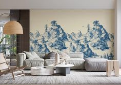 a living room filled with furniture next to a wall covered in blue and white mountains