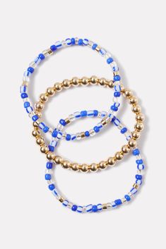 The Celia bracelet set is the perfect summer-ready accessory, featuring a trio of beaded bracelets in a gold, blue, and white color palette. Mix and match them with any look. Trendy Blue Jewelry With Faceted Beads, Trendy Blue Bracelets With Faceted Beads, Blue Beaded Bracelets With Gold Beads, Trendy Hand-strung Blue Beads, Trendy Blue Hand-strung Beads, Blue Stretch Bracelet With Gold Beads, Blue Stretch Bracelet With Gold Round Beads, Trendy Blue Stretch Bracelet With Spacer Beads, Blue And White Color Palette