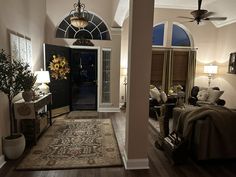 a living room filled with furniture next to a doorway