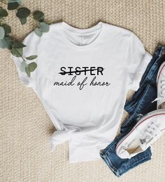 a t - shirt that says sister made of honey on it next to jeans and sneakers