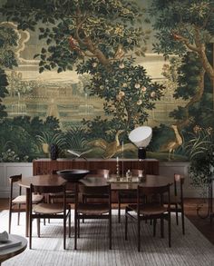 a dining room table with chairs and a large wall mural in the backround