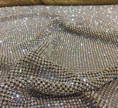 the fabric is shiny and has many small beads on it