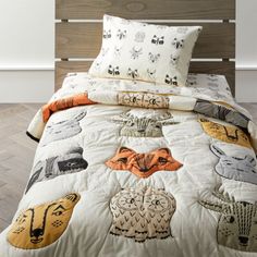 a bed with an animal themed comforter and pillows