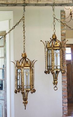 two antique brass hanging lights in a room