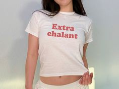 'Extrachalant' Baby Tee The model in the main image is 5'1 and is wearing an XS.  She is 105lb, chest 33C - typically wears an XS - Trendy Y2K Baby tee style for adults - This is a 90s style Baby tee which runs true to size (please see size chart) - 100% cotton (180 g/m²) Our main production is in California, US but we ship from distribution hubs located around the world including Canada, Europe, UK & Australia to reduce shipping time.  If your country isn't currently listed, please reach out an White Stretch Y2k T-shirt, White Y2k Style Stretch T-shirt, Y2k White T-shirt With Funny Text, White Y2k T-shirt With Funny Text, Y2k Style Unisex Short Sleeve T-shirt, Baby Tees 90s, Funny Baby Tees, 90s Tshirt, Baby Tees Y2k