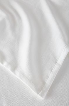 the white sheets are folded on top of each other in this close up shot,