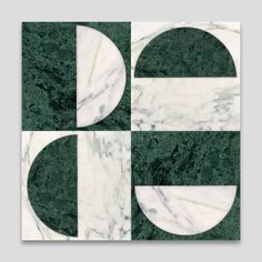 an art deco tile design in green and white with two circles on the middle one