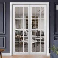 a living room with two glass doors and furniture