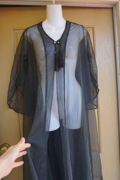 "Vintage black sheer robe. 70s era. Great condition. Measurements taken across front laid flat 20\" across front armpit to armpit -doubles to 40 around 37\" across waist 52\" length" Bohemian Sheer Cover-up For Party, Black Sheer Bohemian Cover-up, Long Sheer Cover-up For Party, Black Sheer Robe, Embroidery Aprons, Sheer Robe, Womens Lingerie, Romantic Boho, 70s Era