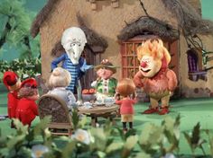 an animated scene with people and animals in front of a house